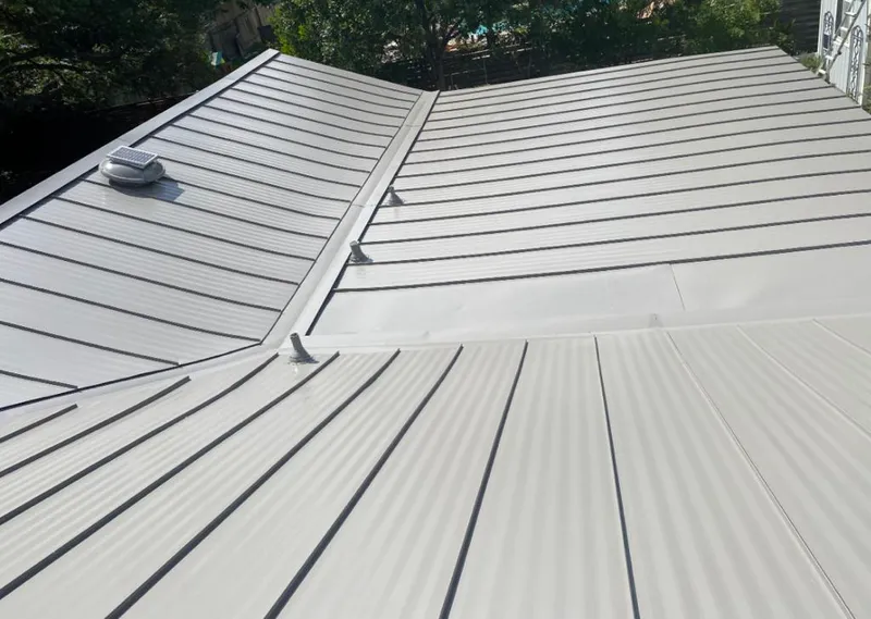 Solar attic fan installed on a metal roof for Roof Ventilation in Acworth